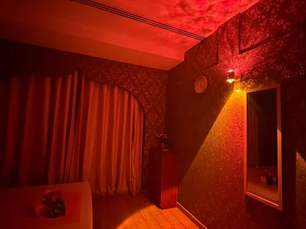 Massage room with mood lighting and full-length mirror