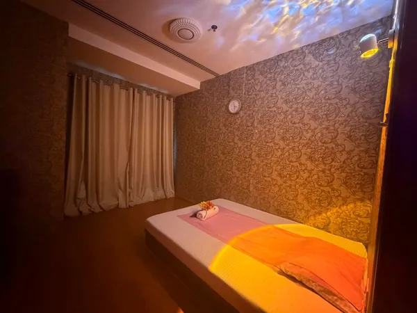 Treatment room with heat lamp and soft curtains